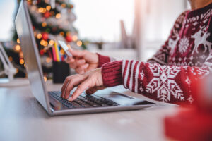 Person using laptop to make holiday purchases.